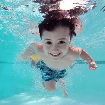The child swim in the pool